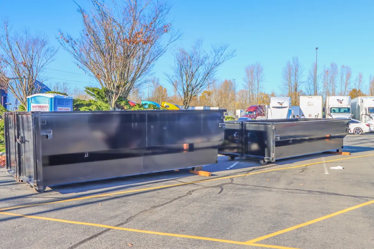 Professional dumpster rental service with roll-off container on residential driveway in Beverly Hills